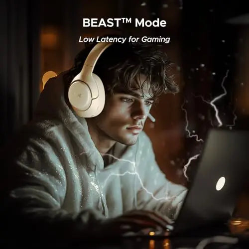Man gaming on laptop with BEAST Mode headphones, low latency feature, Nalanda Enterprises