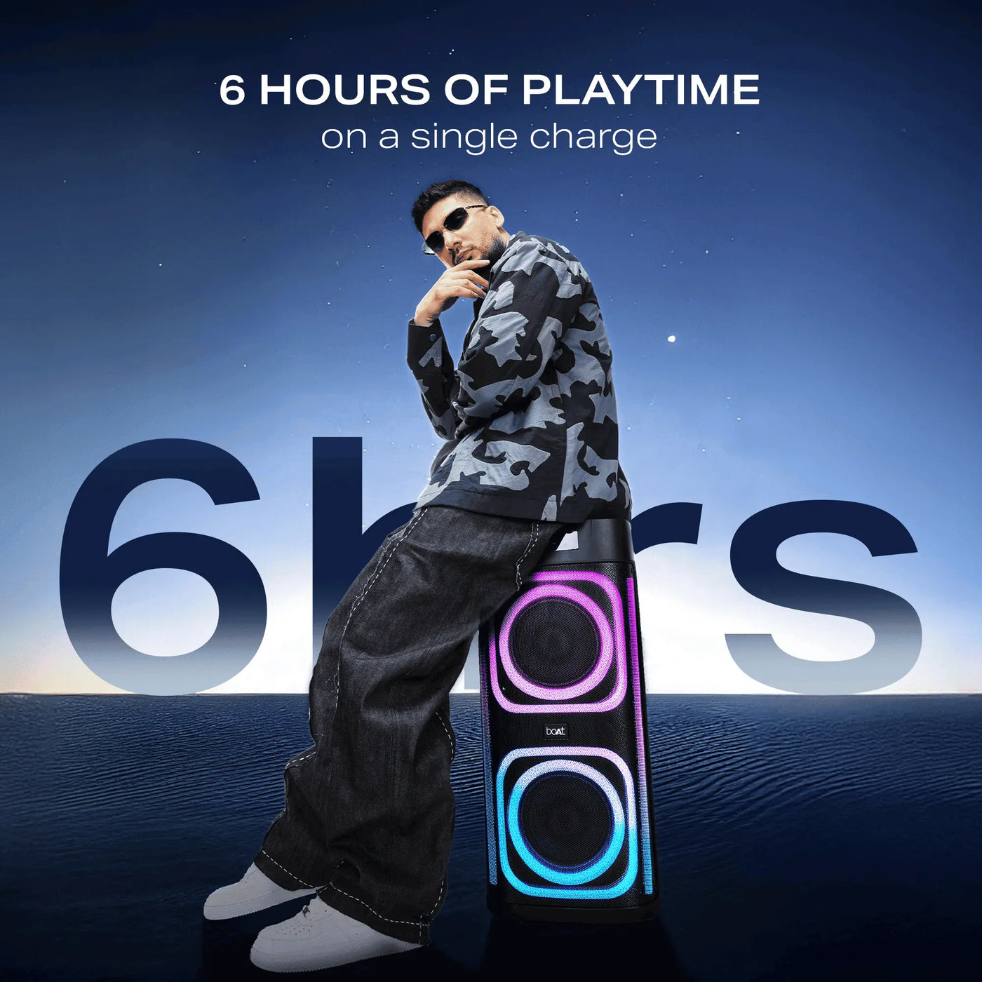 Man in streetwear poses with Boat party speaker showing 6 hours playtime, Nalanda Enterprises